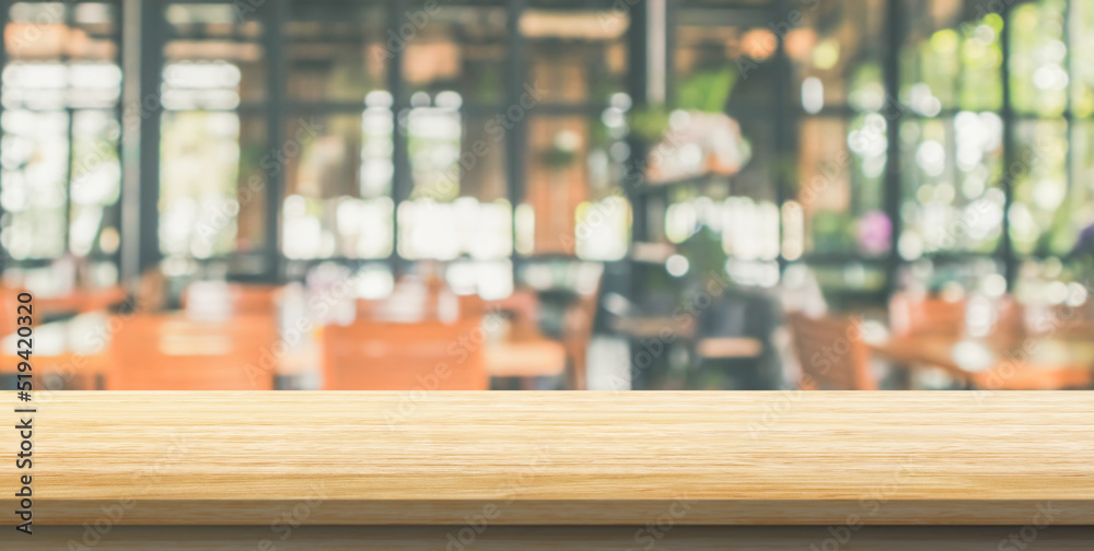 Empty wood table top with cafe restaurant interior blurred background Empty wood table top with cafe restaurant interior blurred background
