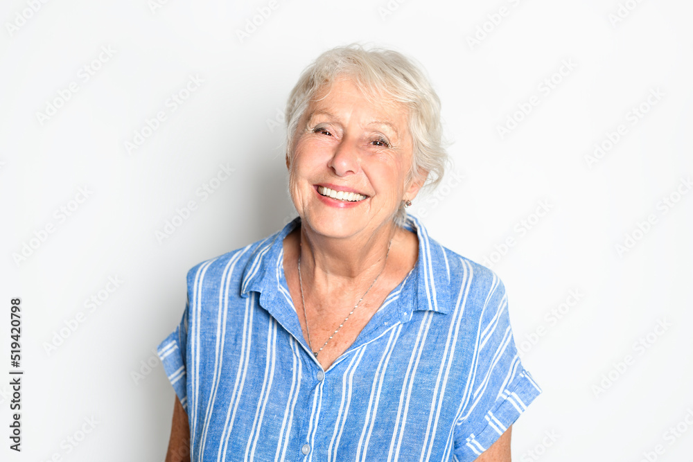 smiling retired senior woman looking at camera isolated on white background smiling retired senior woman looking at camera isolated on white background