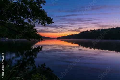 Fototapeta Naklejka Na Ścianę i Meble -  Pemaquid River in Maine is calm and vibrant with deep purple hues on a summer morning at sunrise