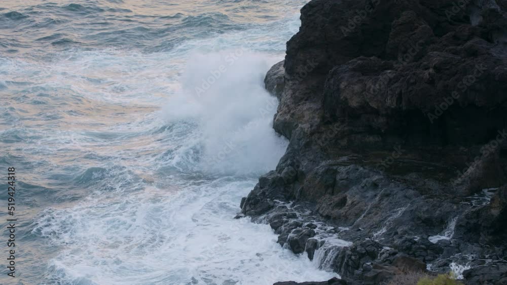 Storm in the Atlantic Ocean Waves Break the rocks of the shore Water turns into Foam Droplets and Splashes Clear Blue water of the Sea. Gale Tide is playing with the Sun shot slow motion