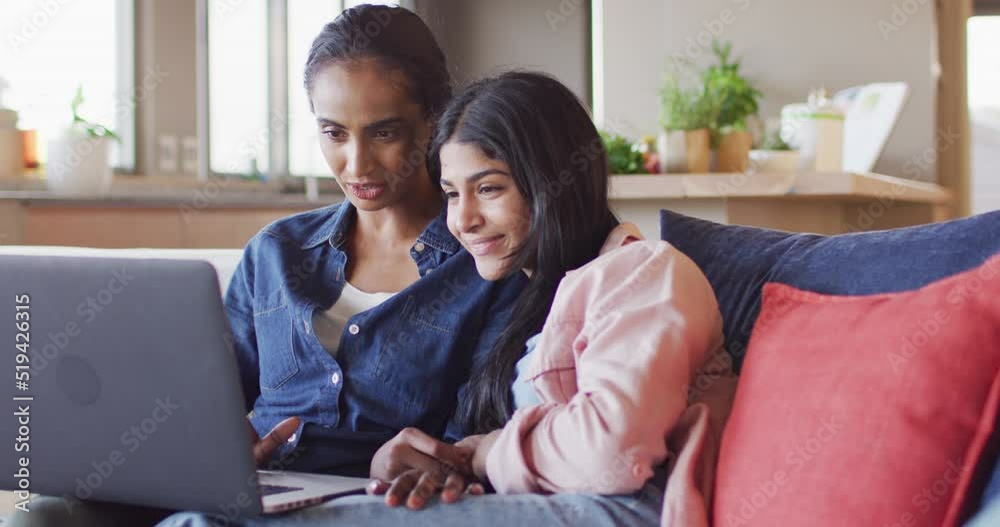 Video of happy diverse female friends using laptop on sofa Video of happy diverse female friends using laptop on sofa