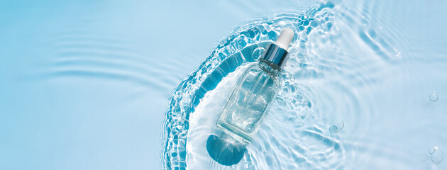 Moisturizing serum with hyaluronic acid in a transparent bottle with a pipette on a transparent water blue background with waves and ripples