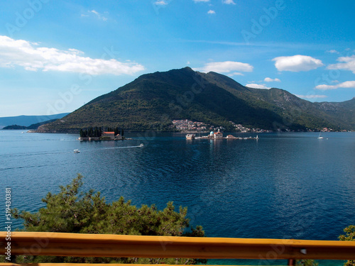 Beautiful view of the bay with mountains and blue sky in the background, The two islands off Perast, Our Lady of the Rocks, artificial island, Gospa od krpjela, Saint George island, Sveti ore photo