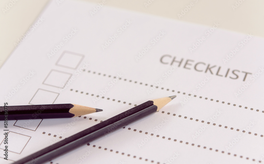 Checklist concept - checklist form paper and pencil on white table Checklist concept - checklist form paper and pencil on white table