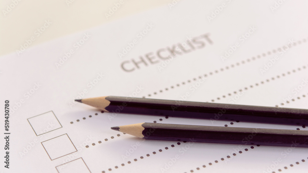 Checklist concept - checklist form paper and pencil on white table Checklist concept - checklist form paper and pencil on white table