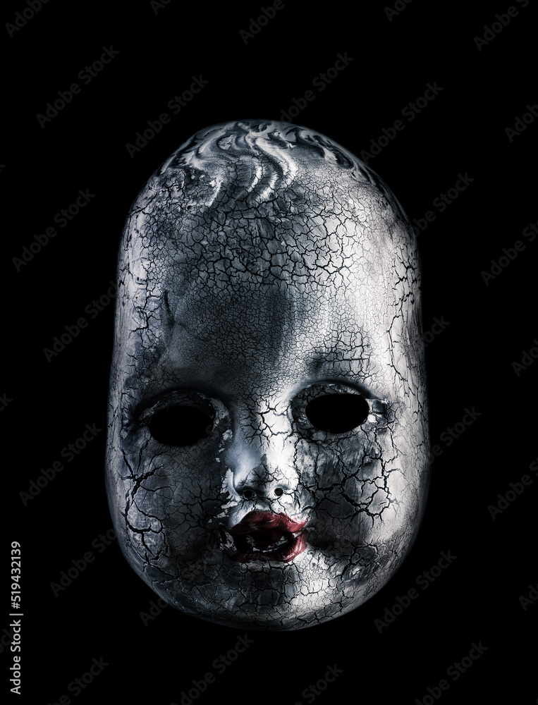 Old cracked creepy doll head isolated on black background Old cracked creepy doll head isolated on black background
