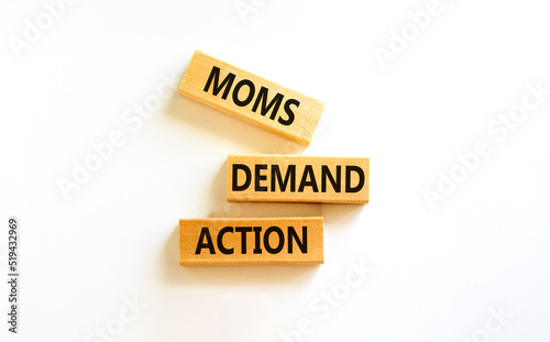 Moms demand action symbol. Concept words Moms demand action on wooden blocks on a beautiful white table white background. Business, finacial and Moms demand action concept. photo