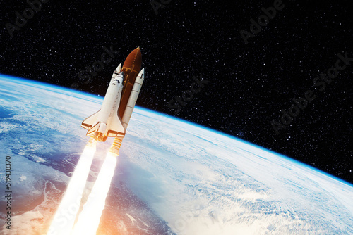 Fototapeta Naklejka Na Ścianę i Meble -  Spaceship lift off. Space shuttle with smoke and blast takes off into the starry sky. Rocket starts into space. Concept. Elements of this image furnished by NASA.