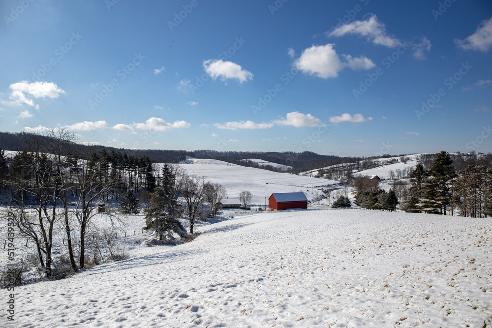 Farm in a snowy valley in the rolling countryside of Amish country, Ohio