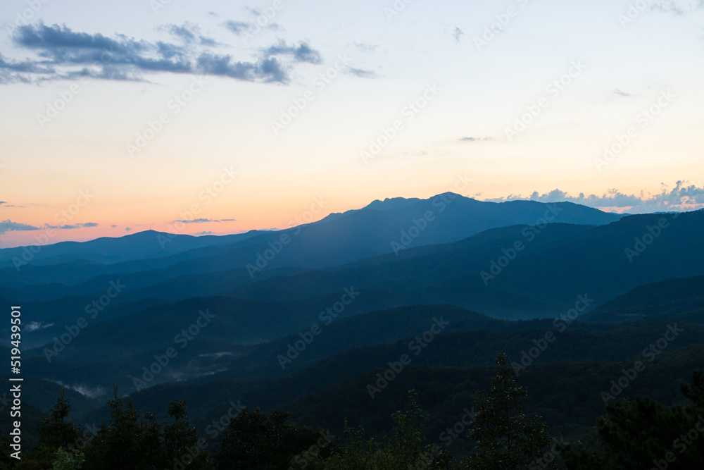 blue ridge mountains at sunset with orange and yellows. blue ridge mountains at sunset with orange and yellows.