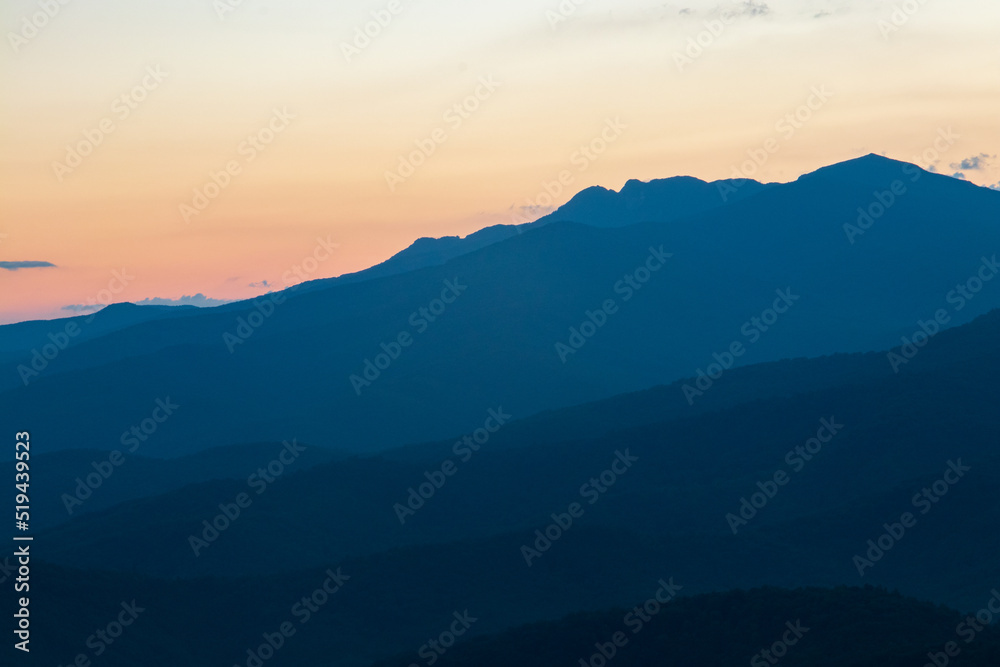 blue ridge mountains at sunset with orange and yellows. blue ridge mountains at sunset with orange and yellows.