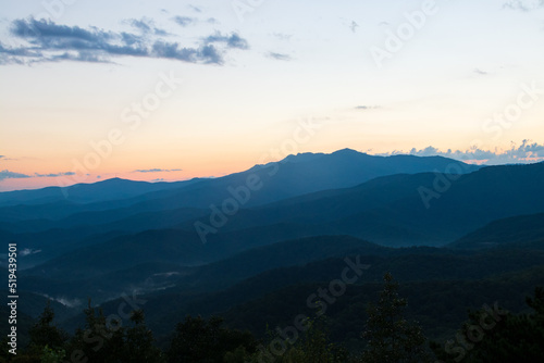 blue ridge mountains at sunset with orange and yellows.