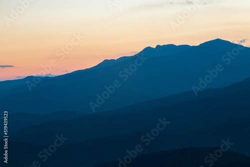 blue ridge mountains at sunset with orange and yellows.