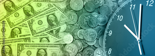 Foto Clock and assorted American coins banknotes. Time is money idea
