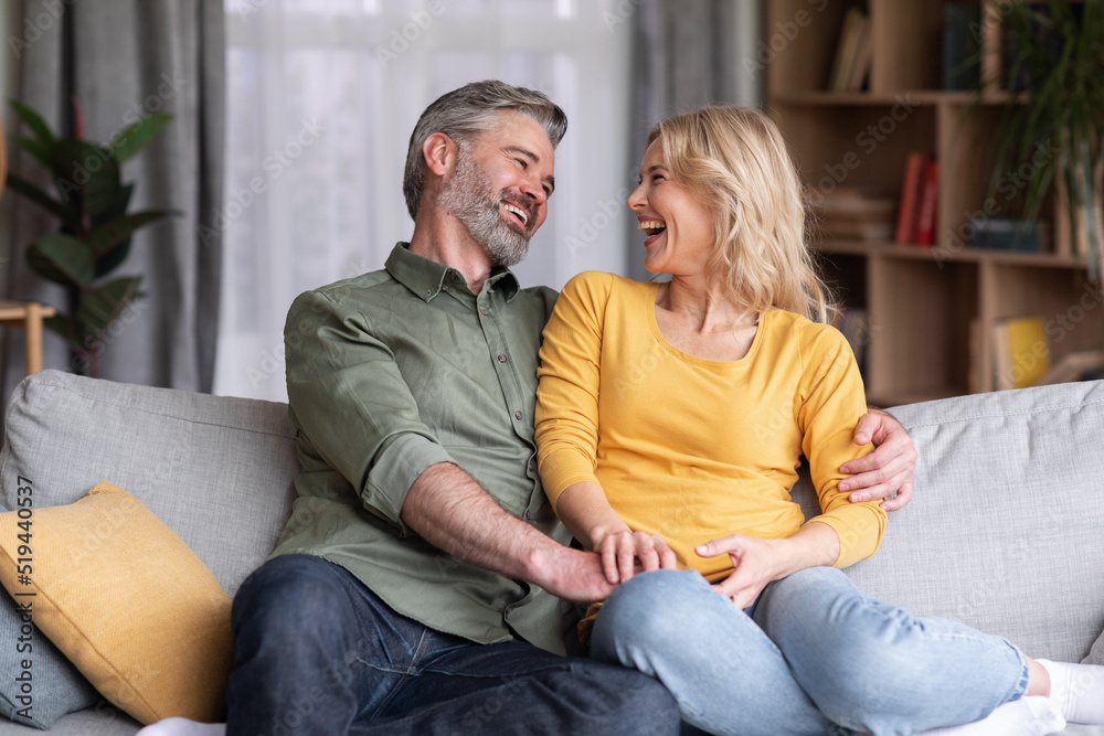 Married Middle Aged Couple Having Fun While Relaxing On Couch At Home Married Middle Aged Couple Having Fun While Relaxing On Couch At Home