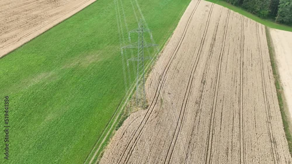 Smooth aerial drone shot of power line pylon. Moving around high voltage power line.