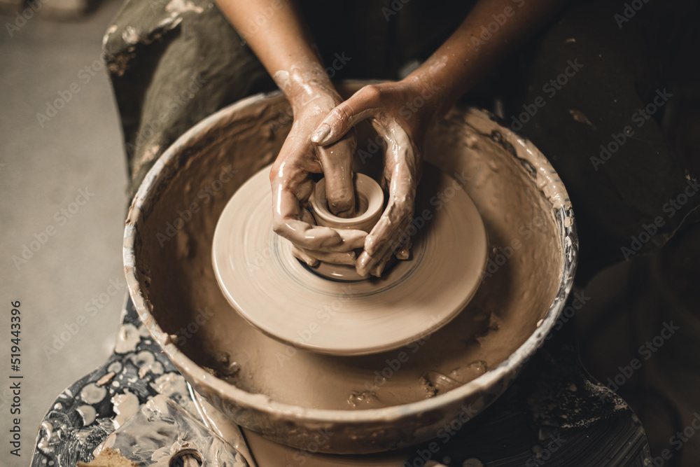 Girl is working with clay.Close up photo.
