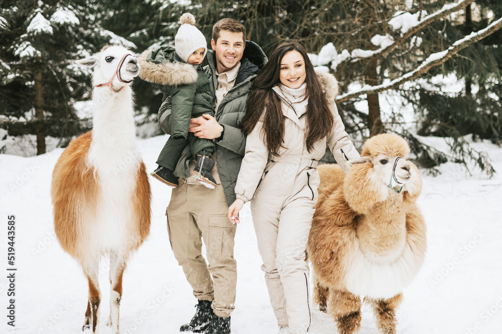family of three young beautiful woman and man fashion stylish winter clothes  overall, baby boy son