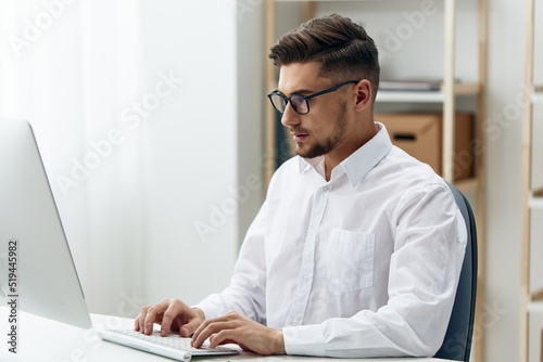 manager wearing glasses sits at a desk office worked executive