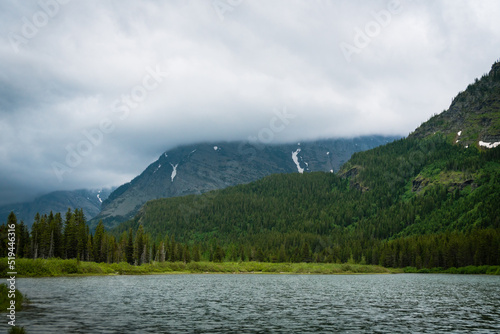 Fishercap Lake in Glacier National Park on a cloudy summer day photo