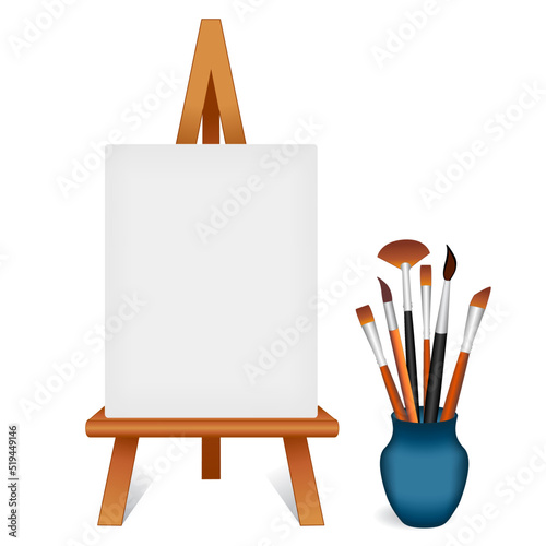 Artist Wood Easel, blank white canvas, portrait orientation, copy space for your custom text or image, assorted paintbrushes in blue vase. Isolated on white background.