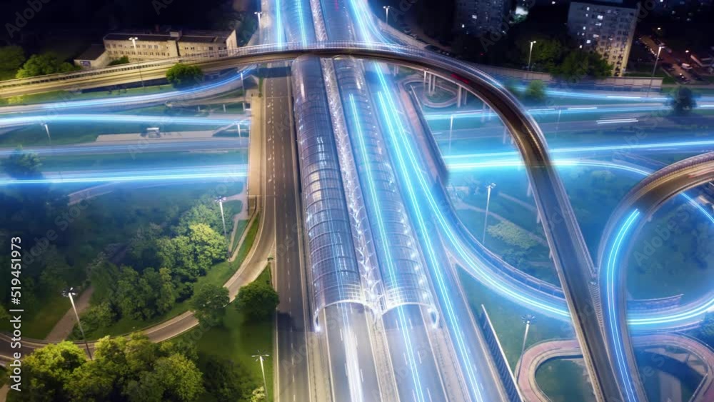 Aerial time lapse hyperlapse multiple road junction in city digital futuristic light trails. Long exposure glowing lines, drone shot city highway roadway at night. Cars driving intersection freeway
