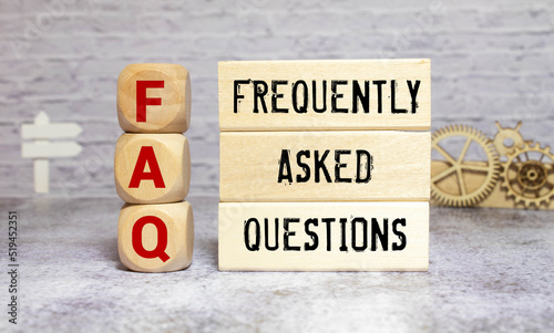 FAQ or frequently asked question concept. Wooden blocks with text on desk.