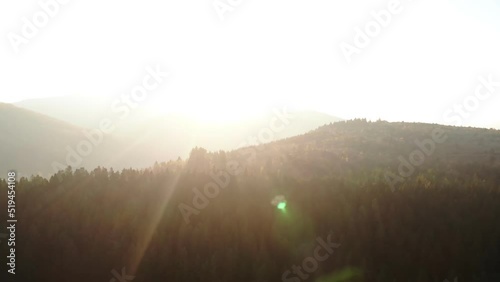 Morning natural landscape in mountains. Bright sun blinds eyes