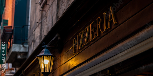 Old rustic signboard with the word pizzeria