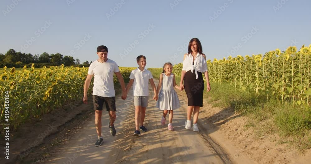 A happy family with two children is walking in nature A happy family with two children is walking in nature