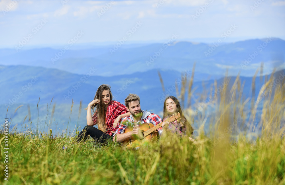 Real relaxation. romantic picnic in tourism camp. campfire songs. group of people spend free time together. family camping. hiking adventure. happy men and girls friends with guitar. friendship Real relaxation. romantic picnic in tourism camp. campfire songs. group of people spend free time together. family camping. hiking adventure. happy men and girls friends with guitar. friendship