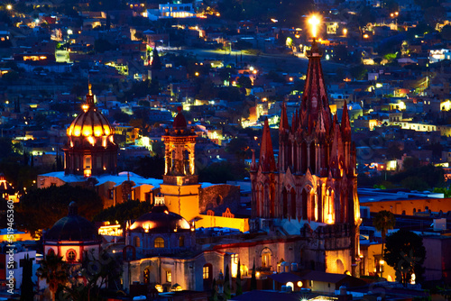 cityscape with parish at night with cross of light in the top, blue hour in san miguel de allende guanajuato  photo