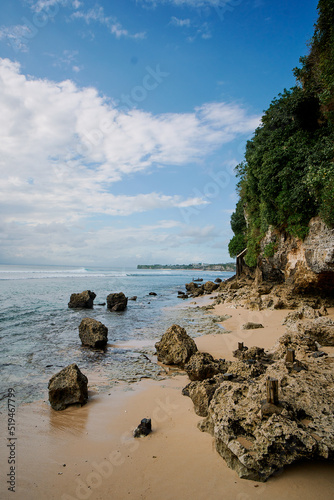 rocks, coastline, sea and sky at padang padang beach in bali indonesia