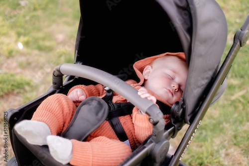 Baby child sleeping in stroller pram