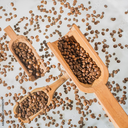 Scoops floating on several planes among coffee beans and white background. Picture with an effect of oil painting.