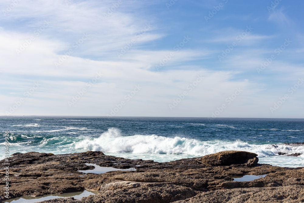A view on Pacific ocean coast with rocks and waves