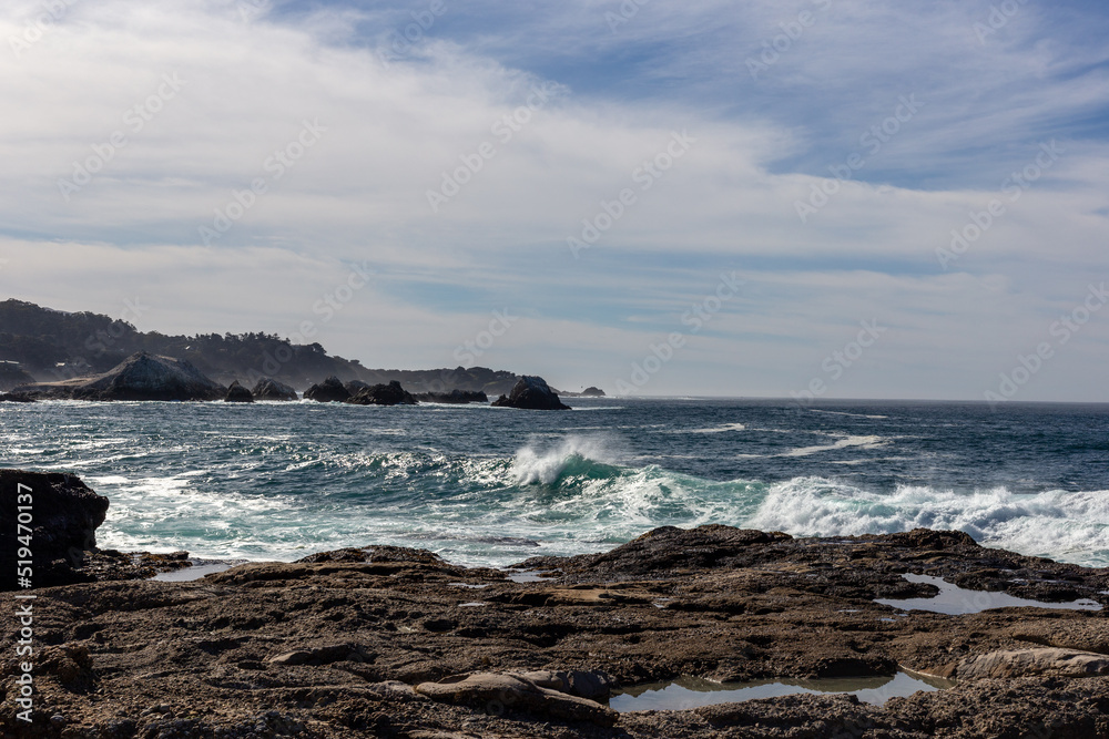 A view on Pacific ocean coast with rocks and waves