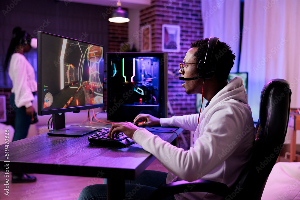 African american man playing action video games on stream online, using computer to play rpg tournament. Male gamer attending esport game championship to broadcast live gaming content.