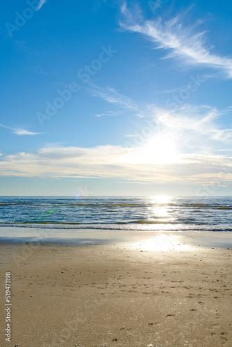 Fototapeta Naklejka Na Ścianę i Meble -  Beautiful, calm and quiet view of the beach, ocean and sea against a cloudy blue sky copy space background on a sunny day. Peaceful, scenic and tranquil landscape to enjoy a relaxing coastal getaway