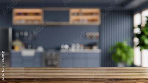 Wooden table top on blur kitchen room background,Modern kitchen room interior. photo