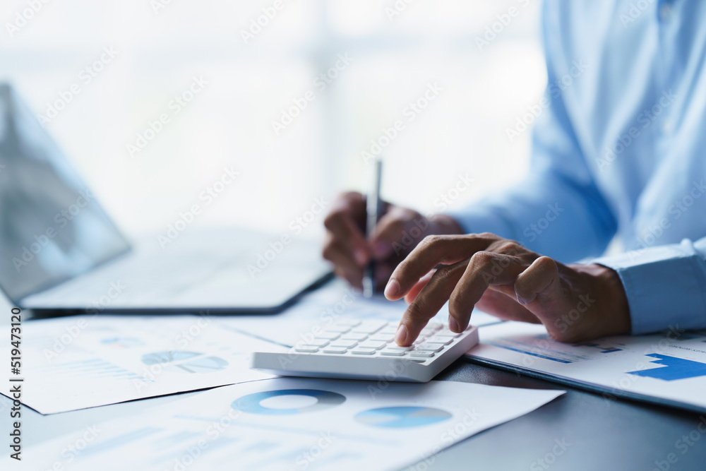 businessman working in office with using calculator and laptop. concept finance and accounting businessman working in office with using calculator and laptop. concept finance and accounting