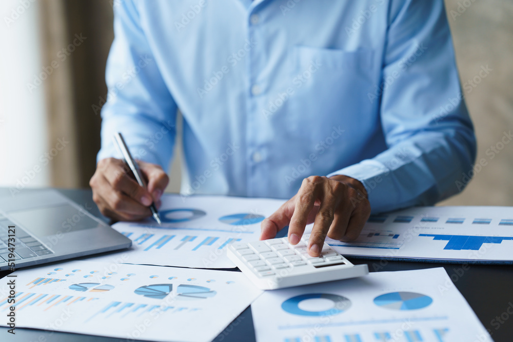 businessman working in office with using calculator and laptop. concept finance and accounting businessman working in office with using calculator and laptop. concept finance and accounting