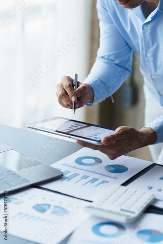 Businessman analysis maketing plan, Accountant calculate financial report, computer with graph chart. Business, Finance and Accounting concepts