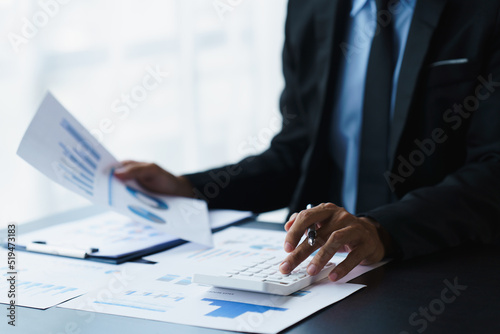 businessman working in office with using calculator and laptop. concept finance and accounting
