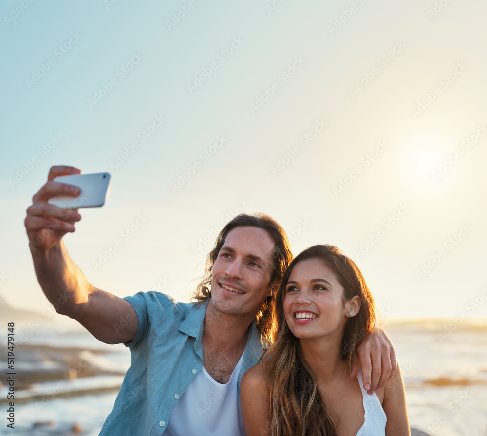 happy couple taking photo using smartphone on beach sharing romantic vacation together happy couple taking photo using smartphone on beach sharing romantic vacation together