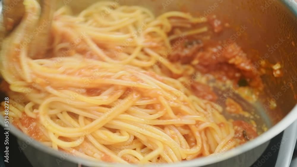Spaghetti with fresh tomato sauce is cooking in a pot.
Spaghetti with fresh tomato sauce is cooking in a pot.