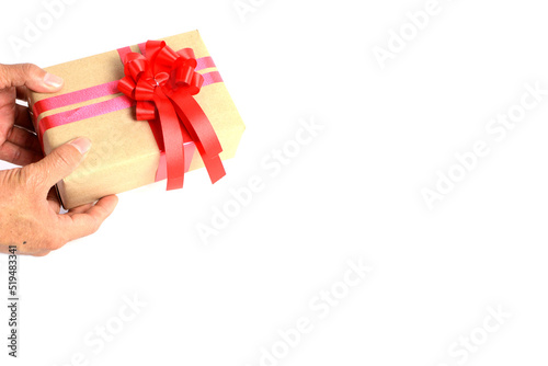 Fototapeta Naklejka Na Ścianę i Meble -  Brown craft gift box with red ribbon bow isolated on white background.