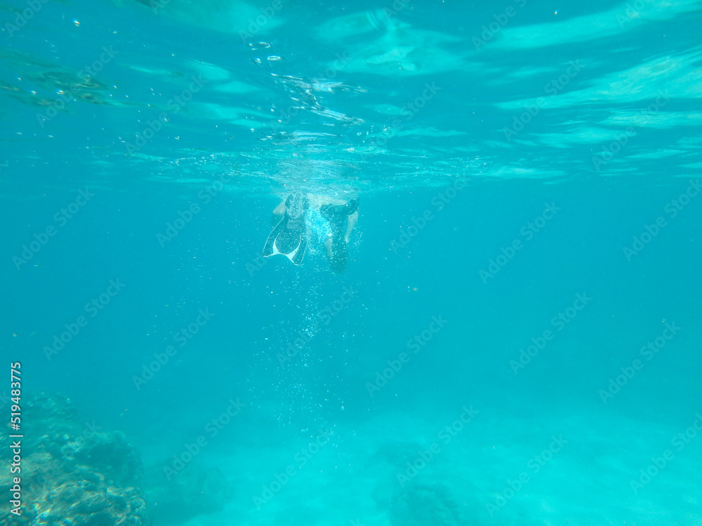 diver vanishing underwater in a distance
