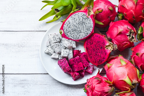 fresh white and pink red purple dragon fruit tropical in the asian thailand healthy fruit concept, dragon fruit slice and cut half on white plate with pitahaya background
