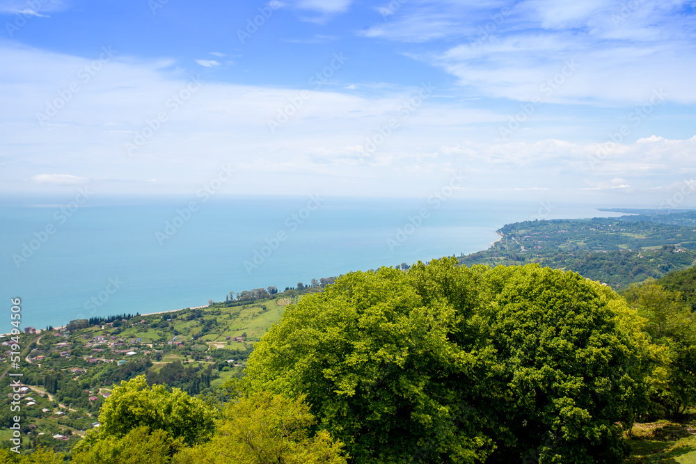 Amazing epic shot of sea coast from top of mountain. Incredible summer views of travel lifestyle. Top of a scenic view of the mountains, town, and sea in a popular tourist destination for vacation